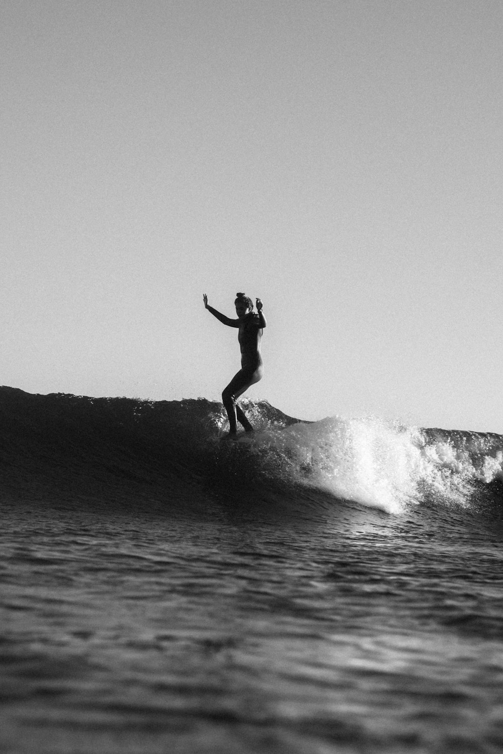 a person riding a wave on top of a surfboard