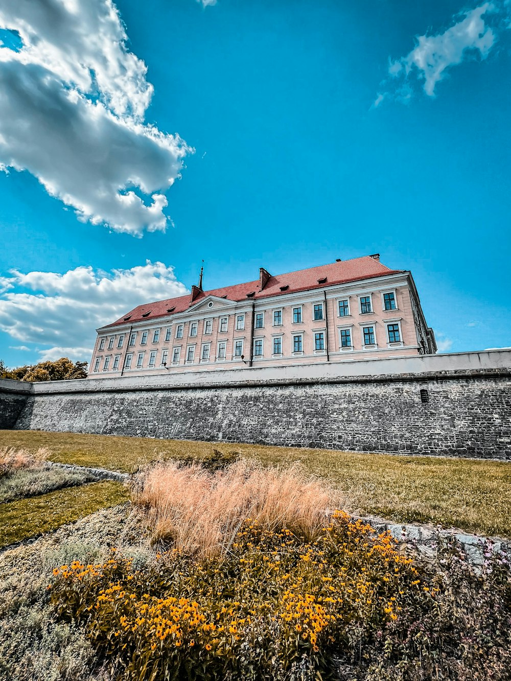 a large building sitting on top of a lush green field