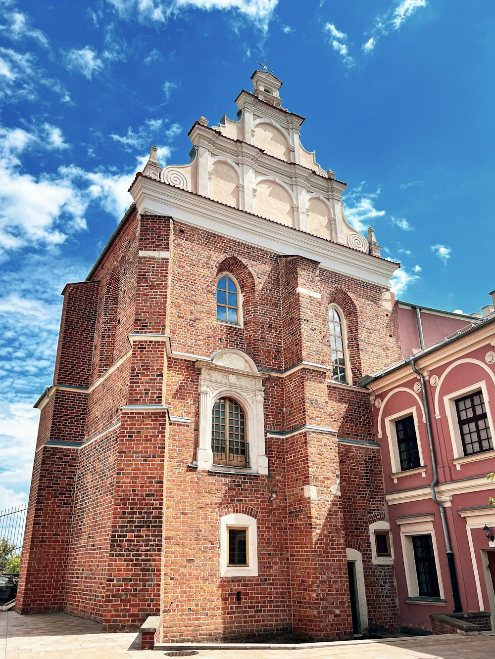 a tall brick building with a clock on it's side