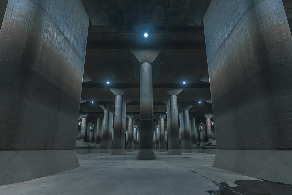 an empty parking garage with columns and lights