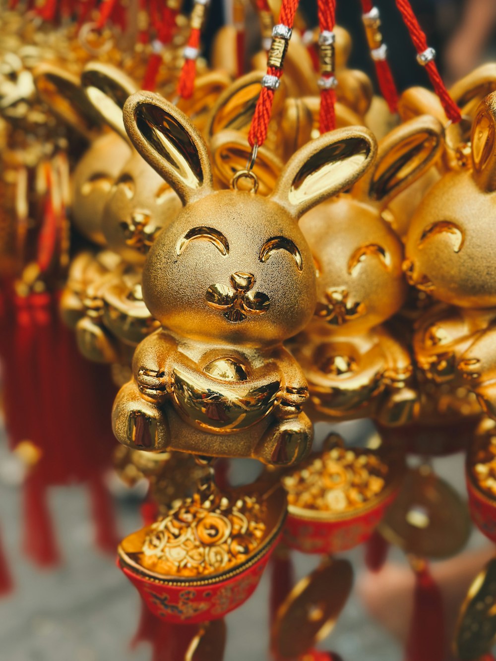 a bunch of gold ornaments hanging from a ceiling