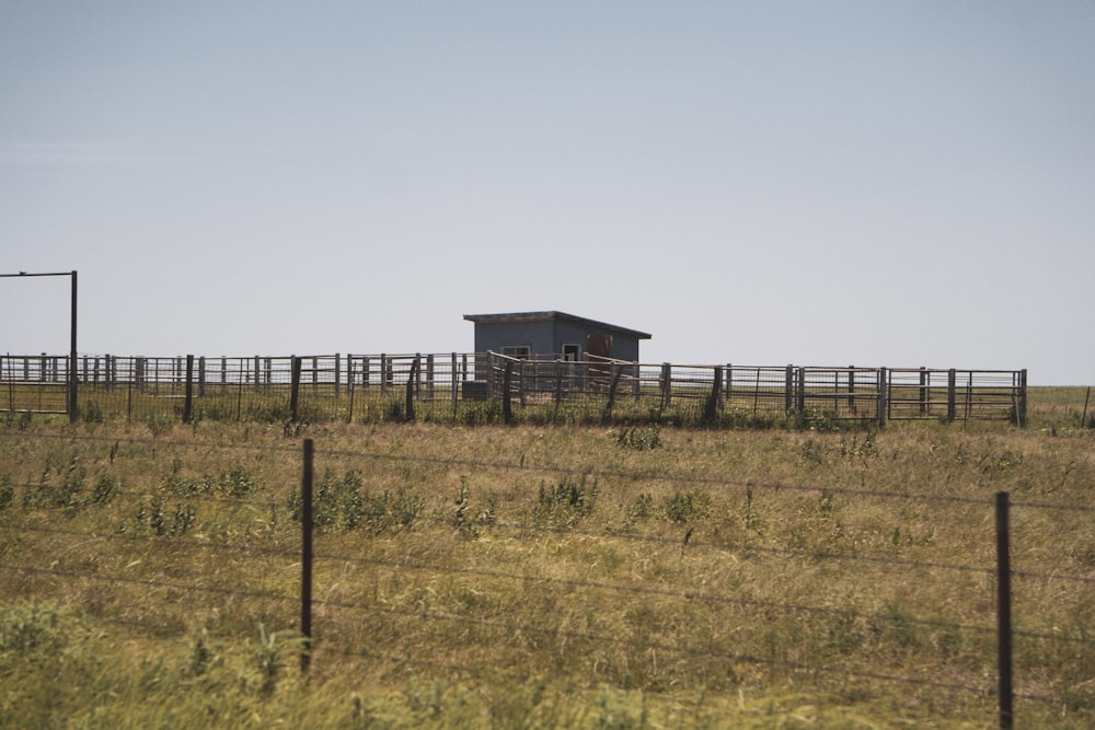 a small building in the middle of a field