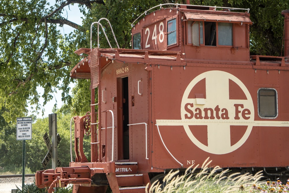 a red train caboose with a santa fe sign on it