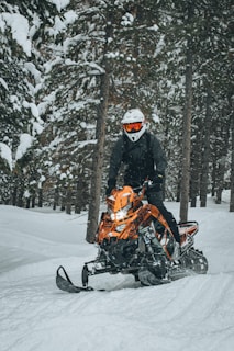 a person on a snowmobile in the snow
