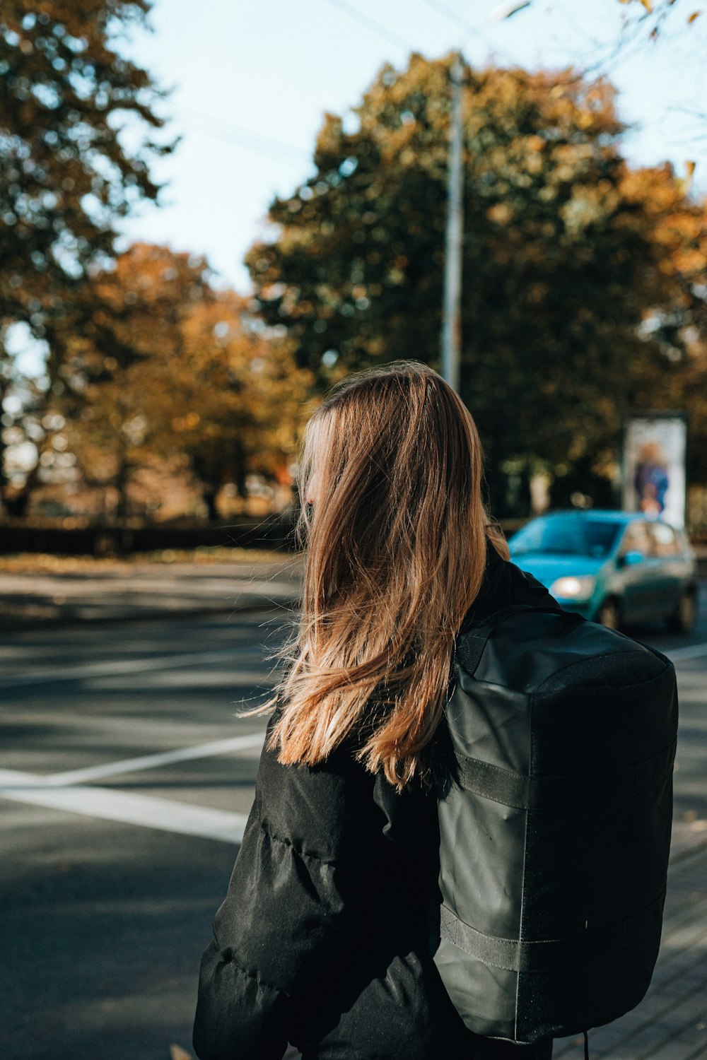 a woman riding a skateboard down a street