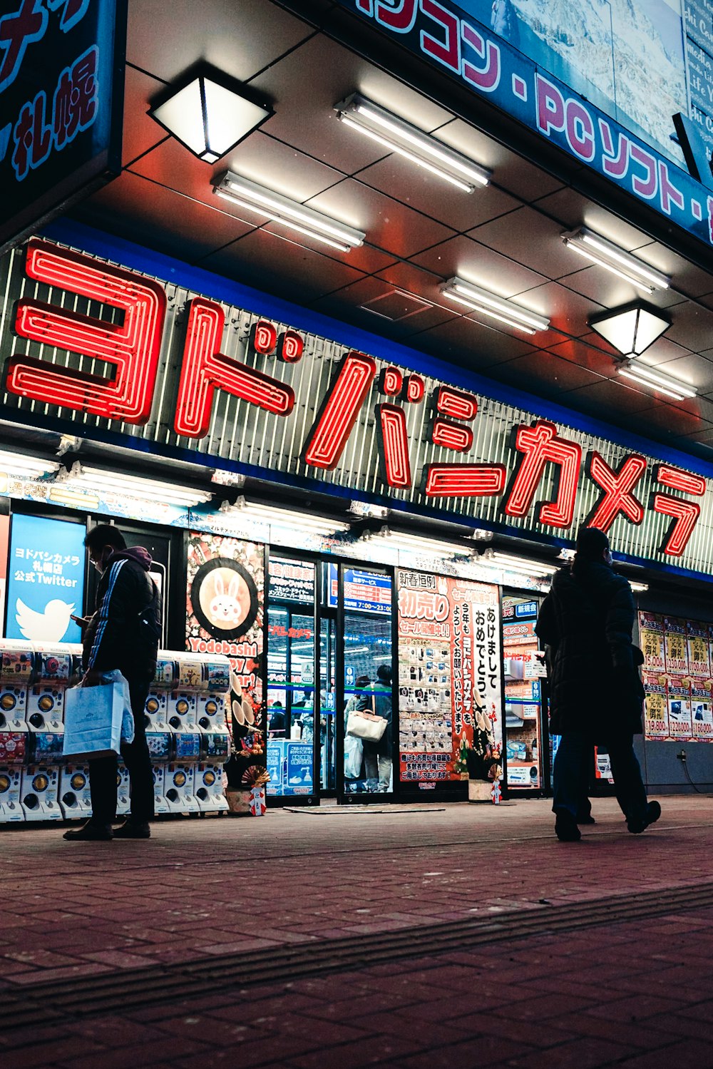 a group of people standing outside of a store