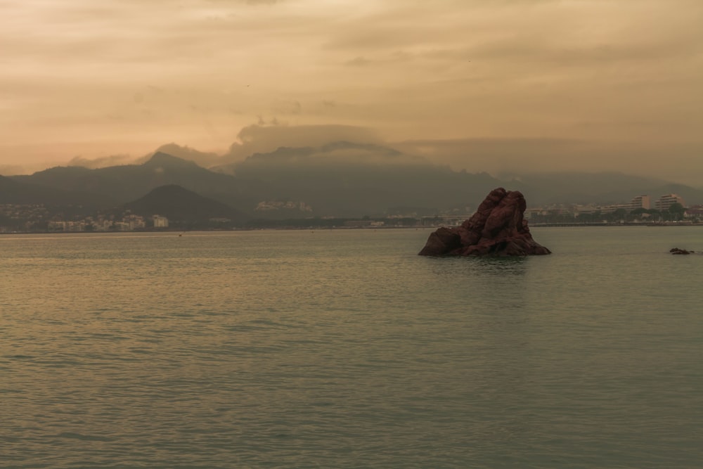 a body of water with mountains in the background