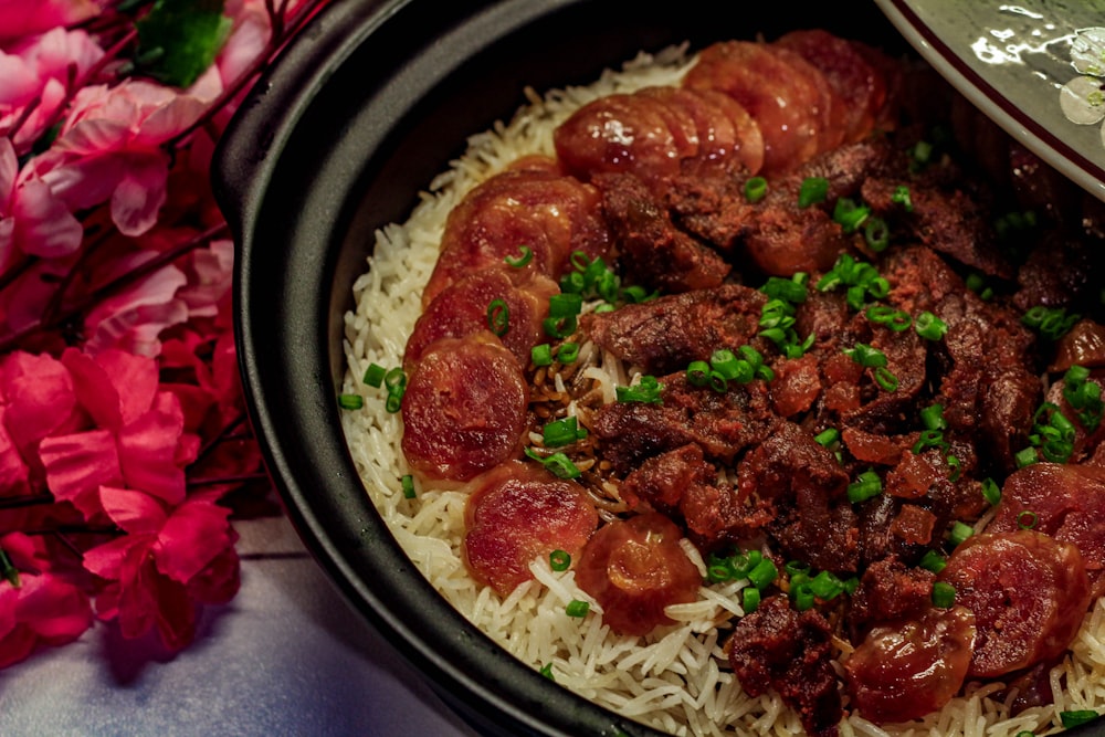 a close up of a plate of food with meat and rice