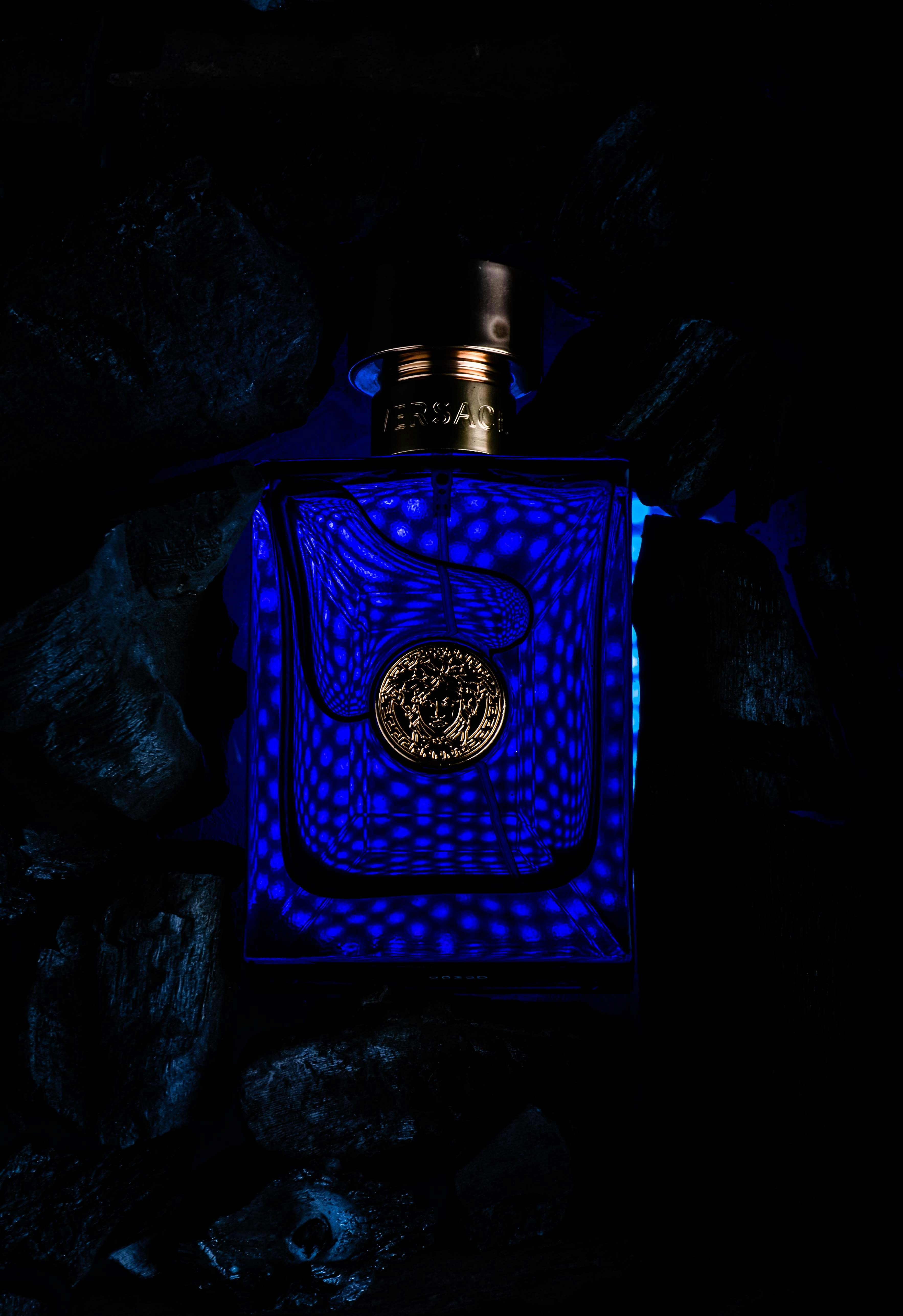 a blue bottle with a gold emblem on it