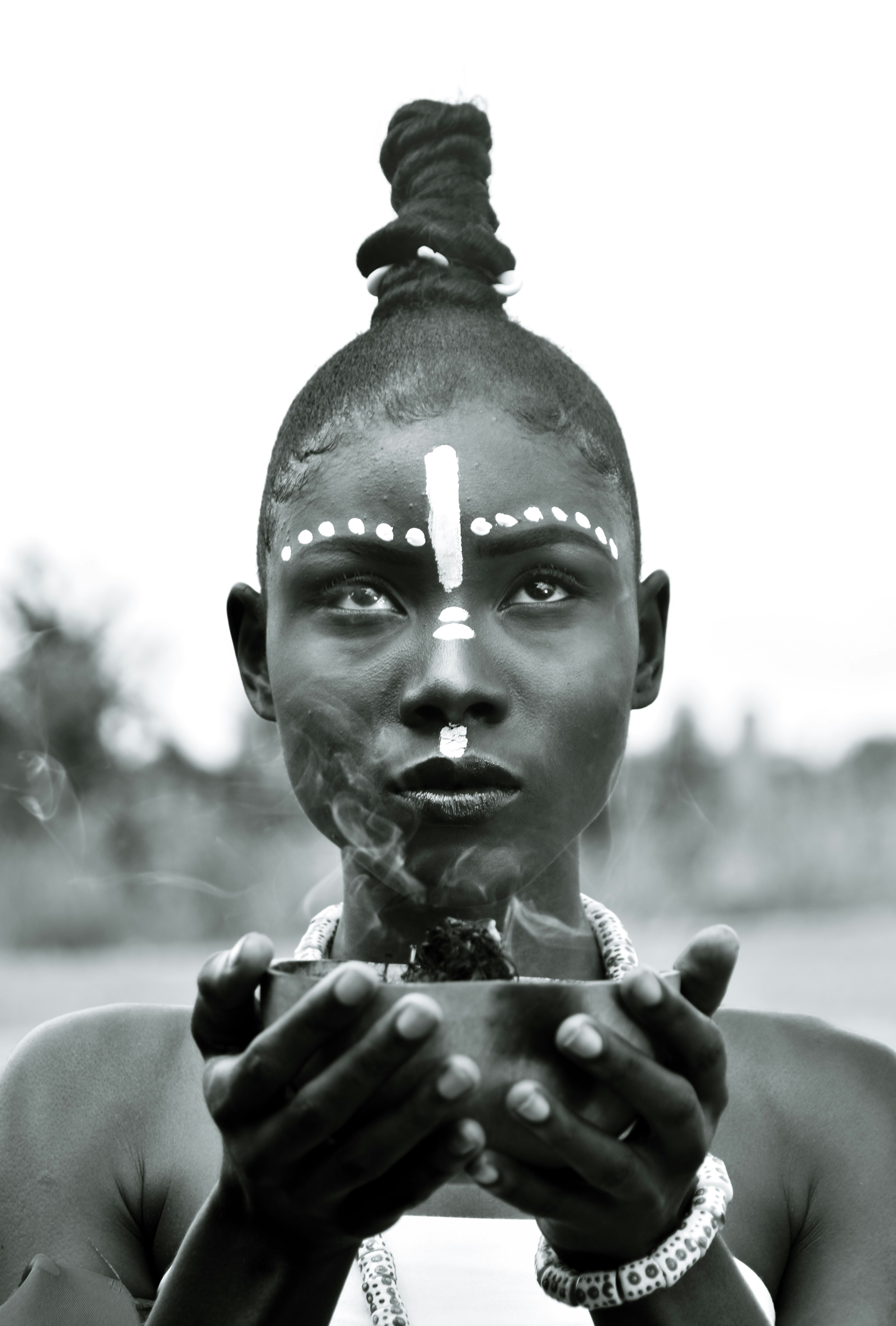 a woman holding a cigarette in her hands