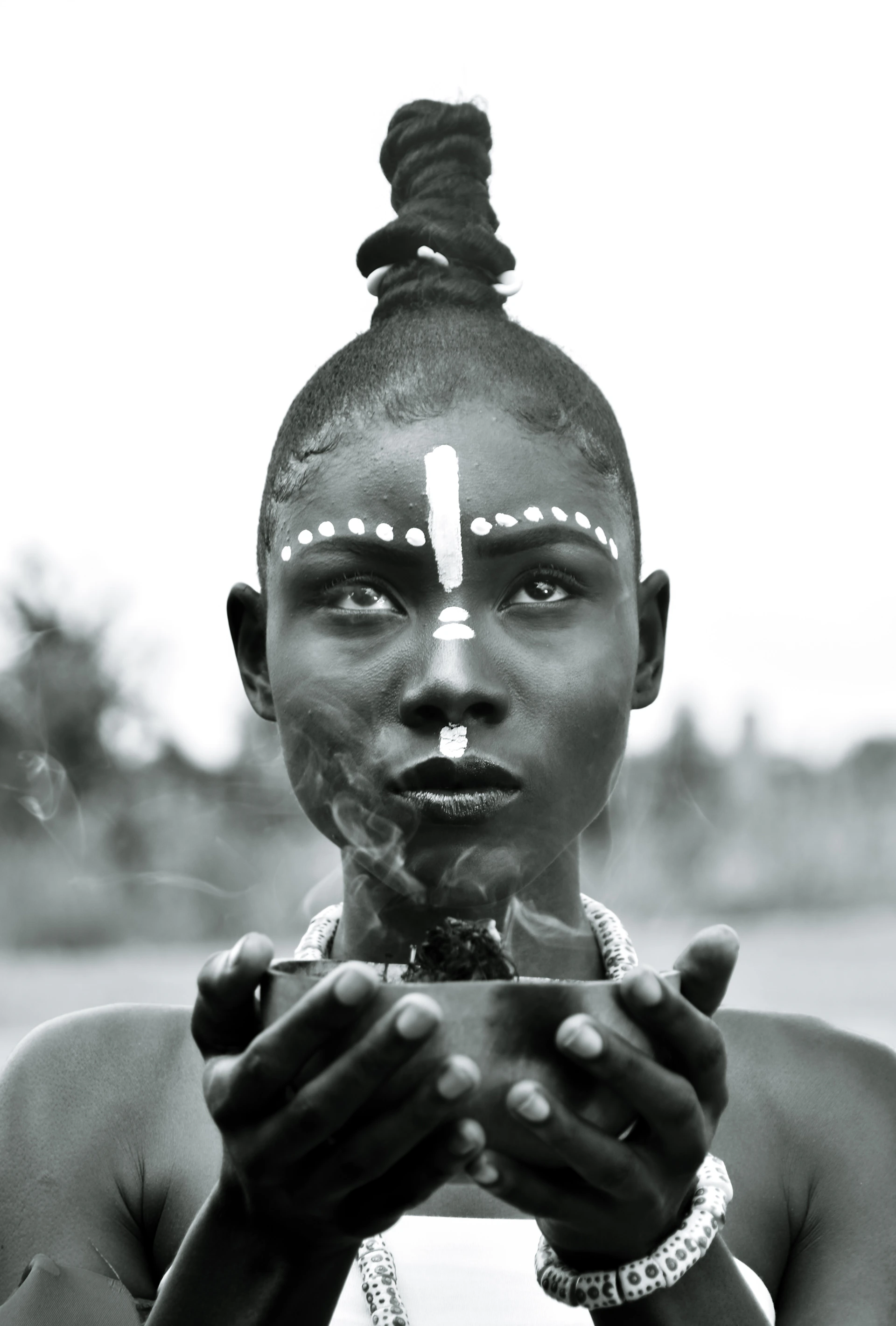 a woman holding a cigarette in her hands