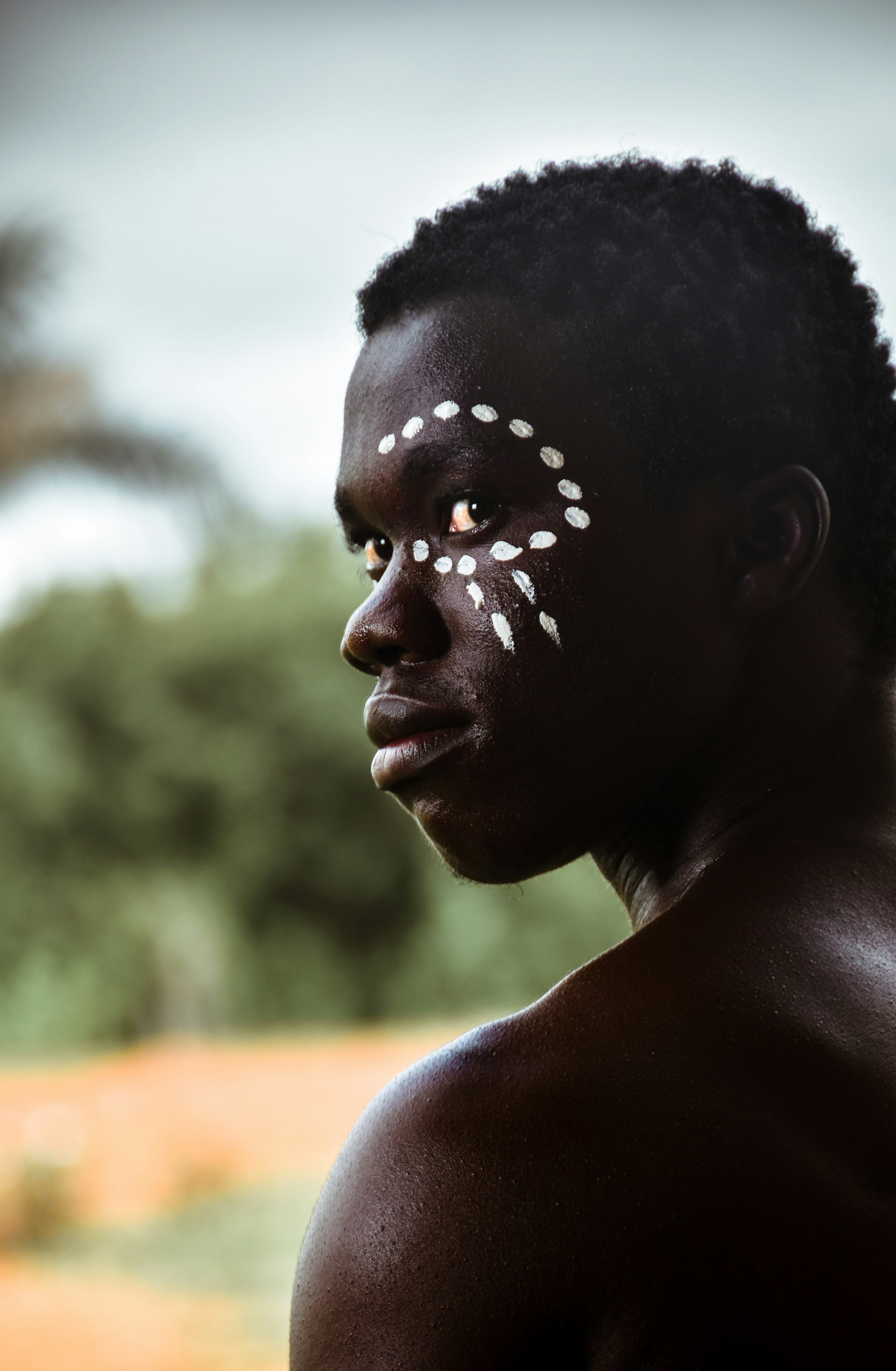 a man with a white face paint on his face