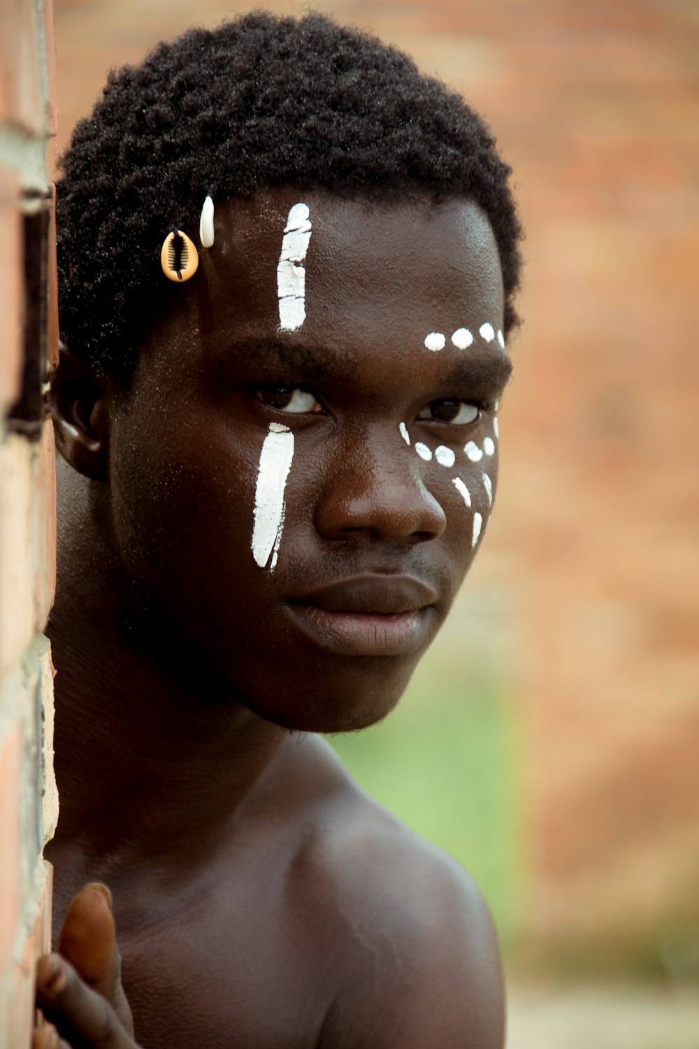 a young boy with white paint on his face