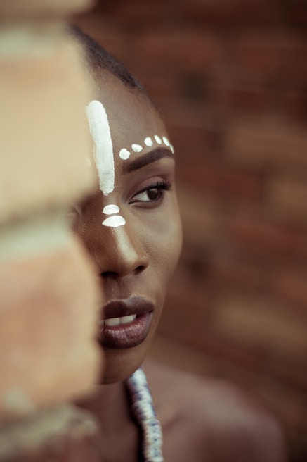 Close-up of an elder from Kinshasa demonstrating the traditional eye technique