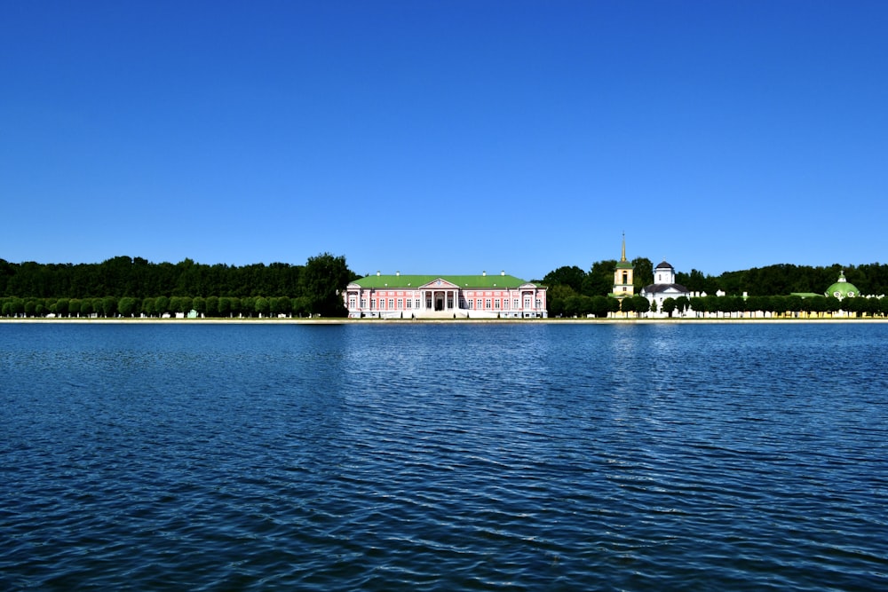 a large body of water with a building in the background