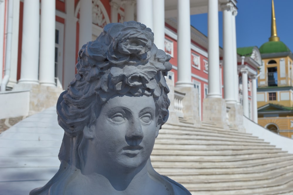 a statue of a woman in front of a building