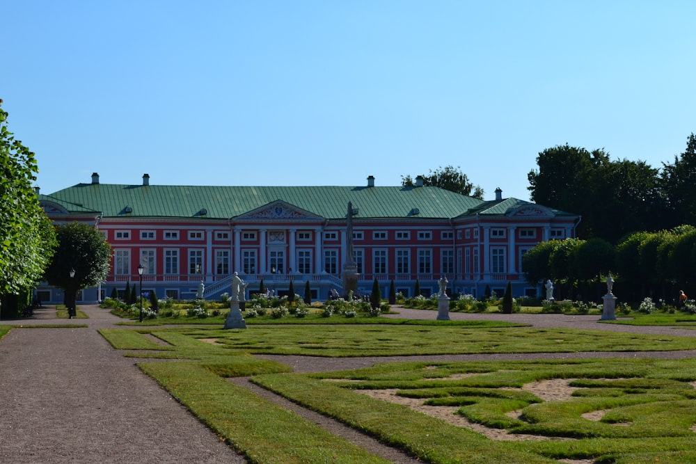 a large red building with a green roof