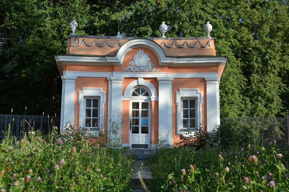 a pink and white building with a clock on top of it