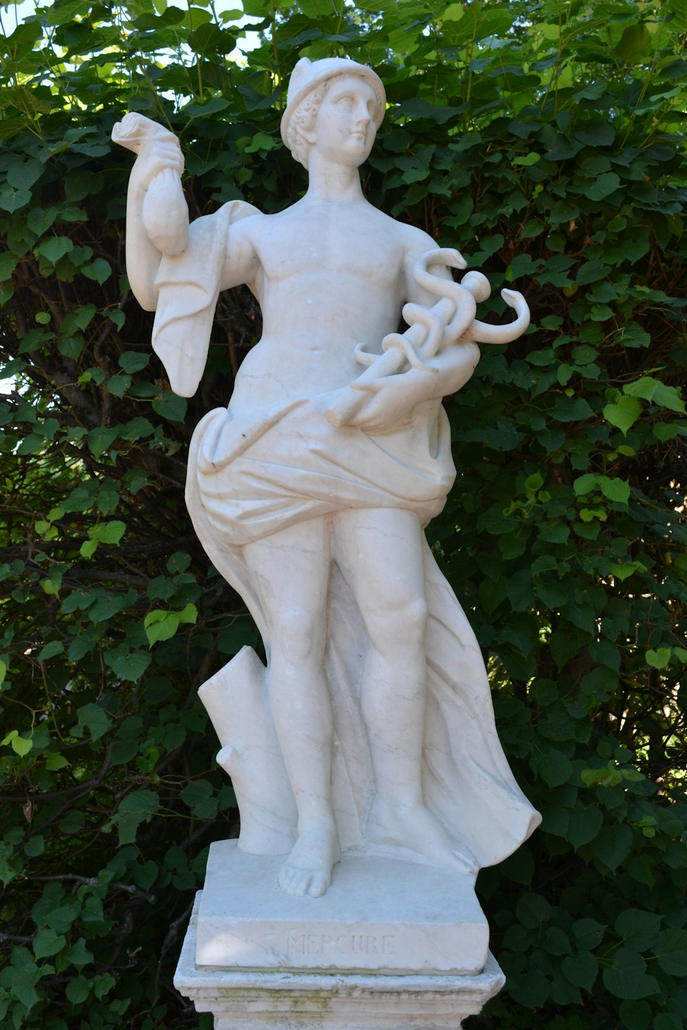 a statue of a man holding a plant