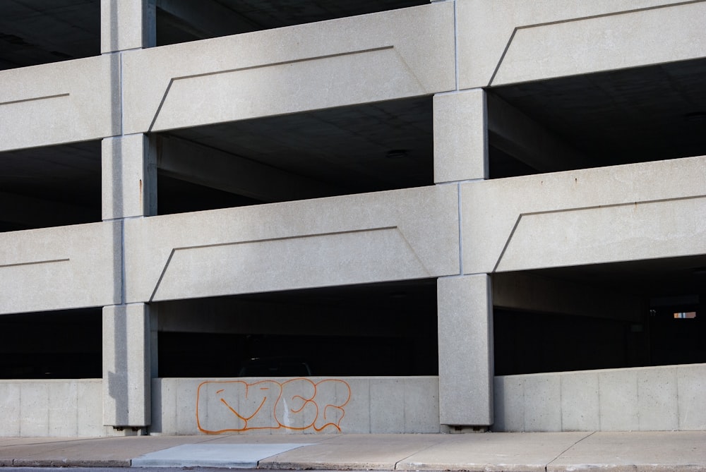 a parking garage with graffiti on the side of it
