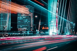 A modern city skyline with fiber optic light trails connecting buildings.