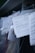 Several documents with Cyrillic text are visible, placed in a stack with clear plastic packaging around them. The focus is on a receipt or invoice in Russian, featuring printed and handwritten text.
