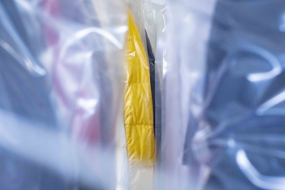a pair of yellow and black toothbrushes wrapped in plastic