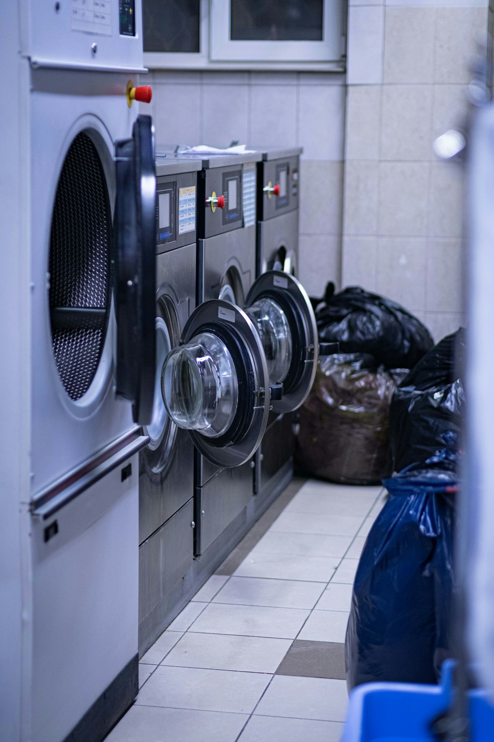 a row of washing machines in a laundry room