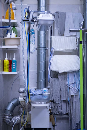 a bathroom with a toilet, shower, and shelves