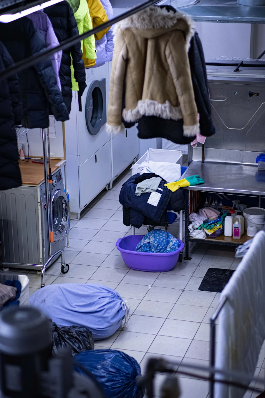 Dry cleaning workspace with garments on racks