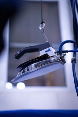 a close up of a stapler with a blue cord