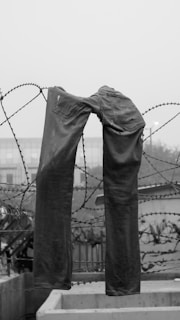 a pair of jeans that are tied to a fence