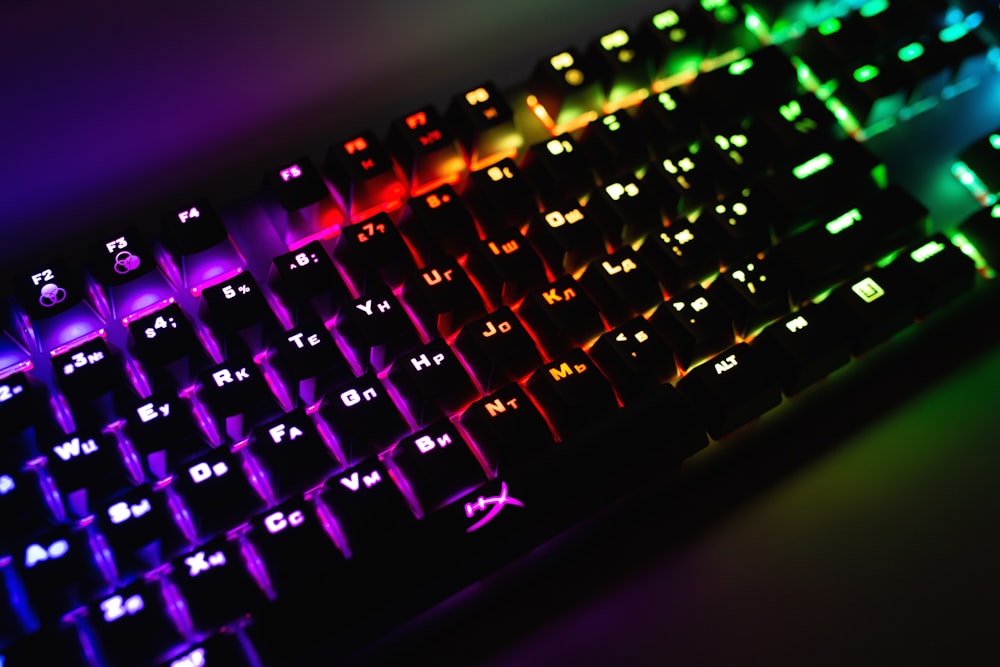 a close up of a keyboard with a rainbow light