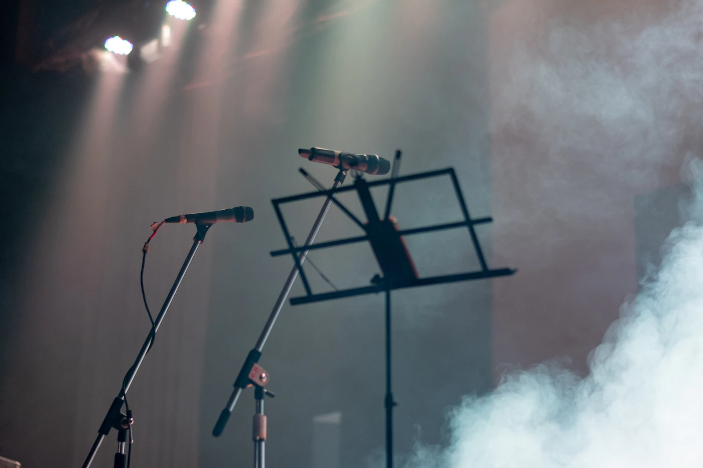 Empty concert microphones under stage lights after Rob Base death news