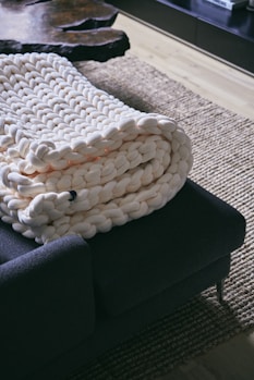 a pile of blankets sitting on top of a couch