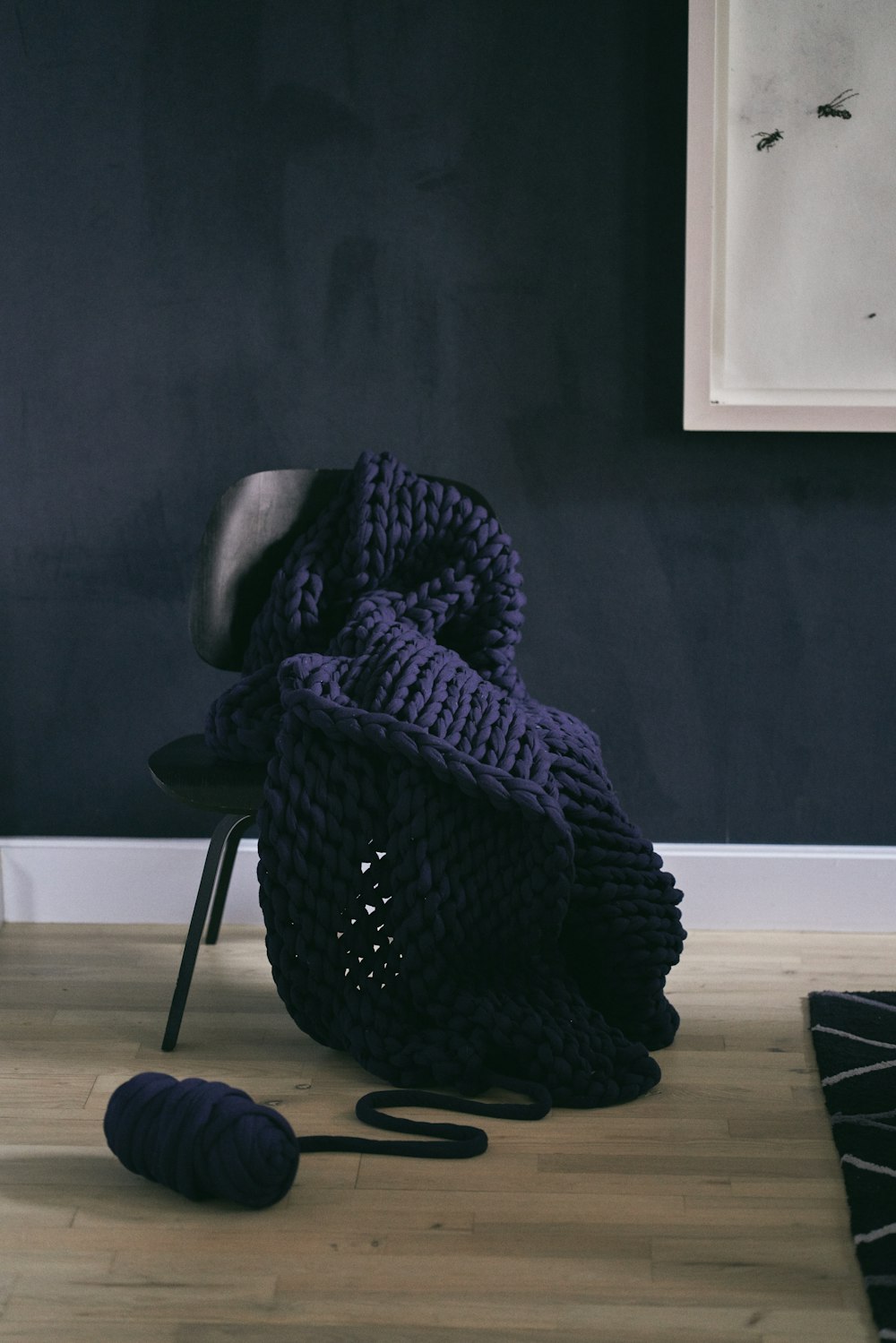 a chair and a ball of yarn on the floor