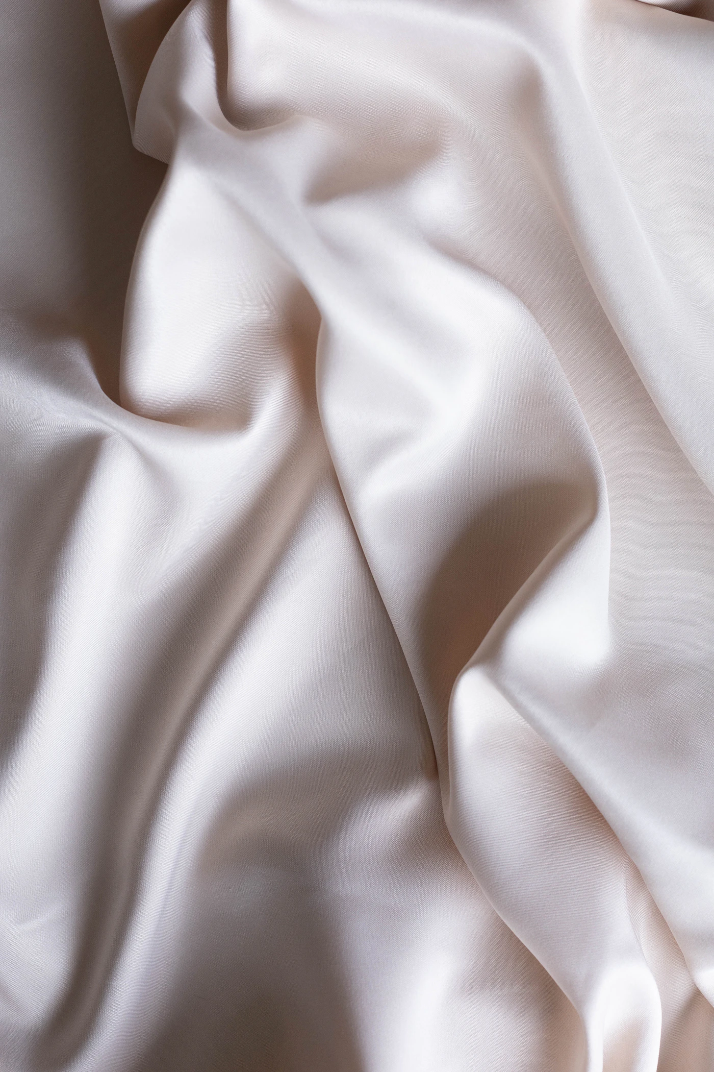 Close-up satin fabric texture used as material reference for premium soft packaging