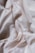 Smooth and flowing white fabric with gentle, soft folds creating an elegant and luxurious texture.