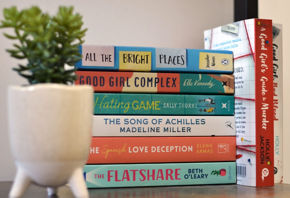 a stack of books sitting on top of a table