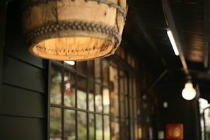A cozy interior of the hut featuring wooden beams and warm lighting.