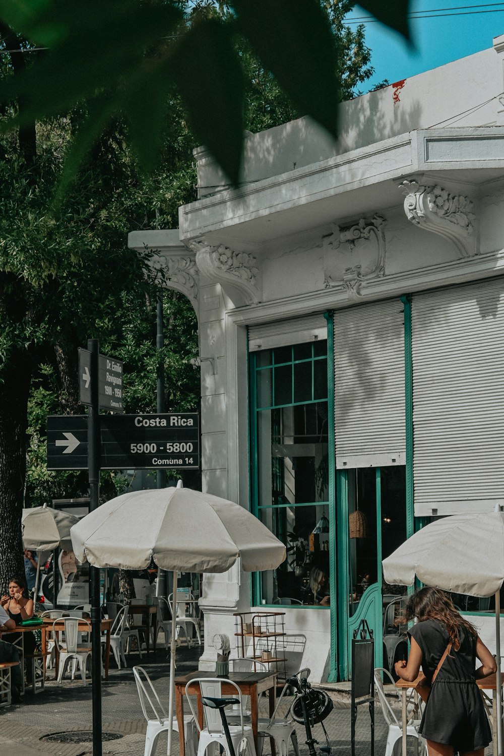 a group of people sitting at tables outside of a building