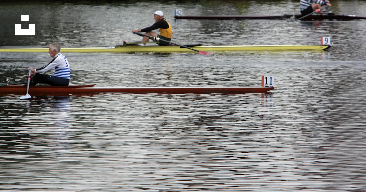 A group of people rowing on a body of water photo – Free Head of the ...