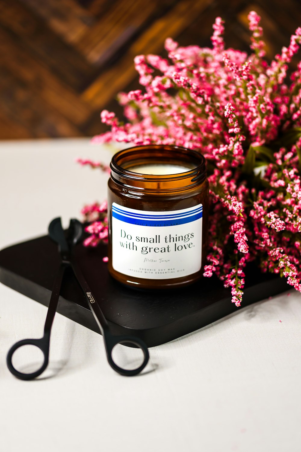 a jar of honey sitting on top of a table next to a pair of scissors