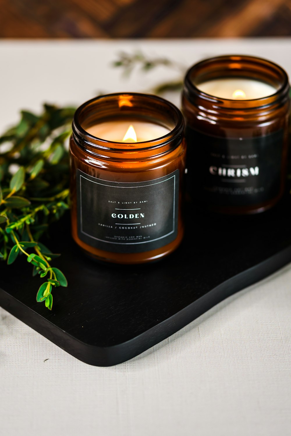 a couple of candles sitting on top of a tray