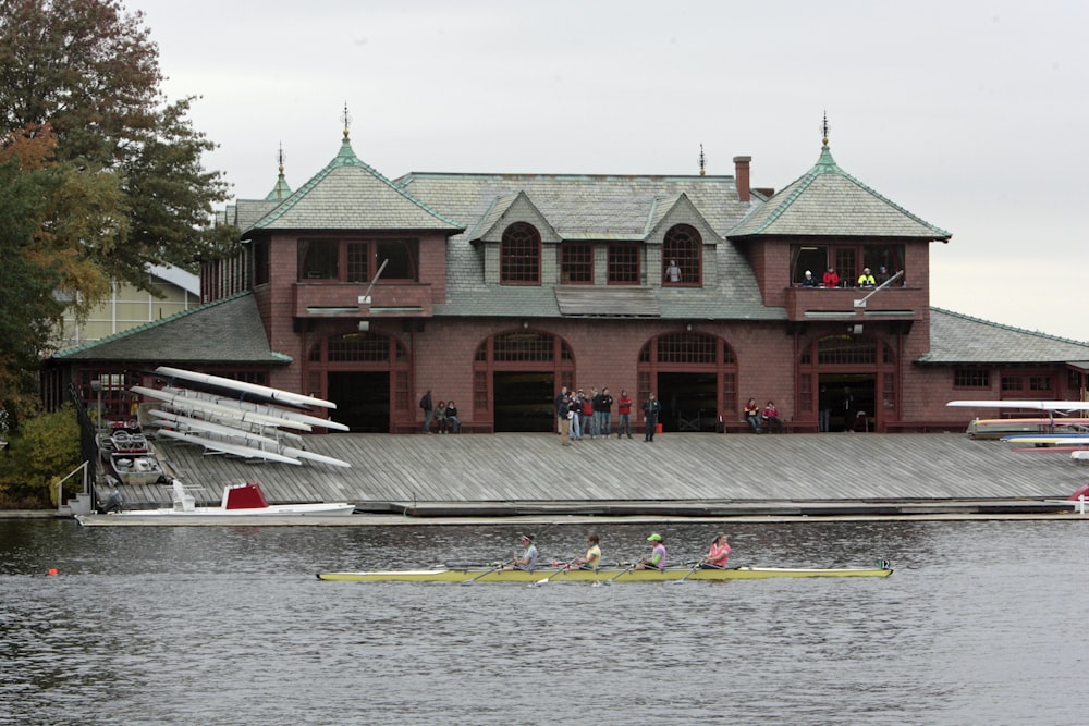 a group of people in a boat on a body of water