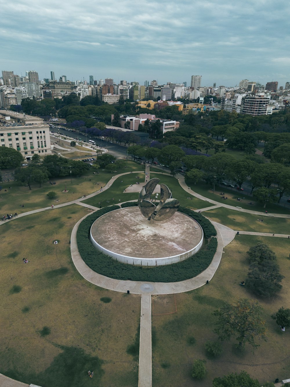 an aerial view of a park with a statue in the center