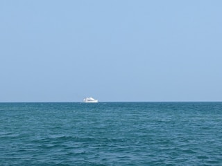 A stunning ship sailing on the ocean under a clear blue sky.