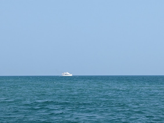 A stunning ship sailing on the ocean under a clear blue sky.