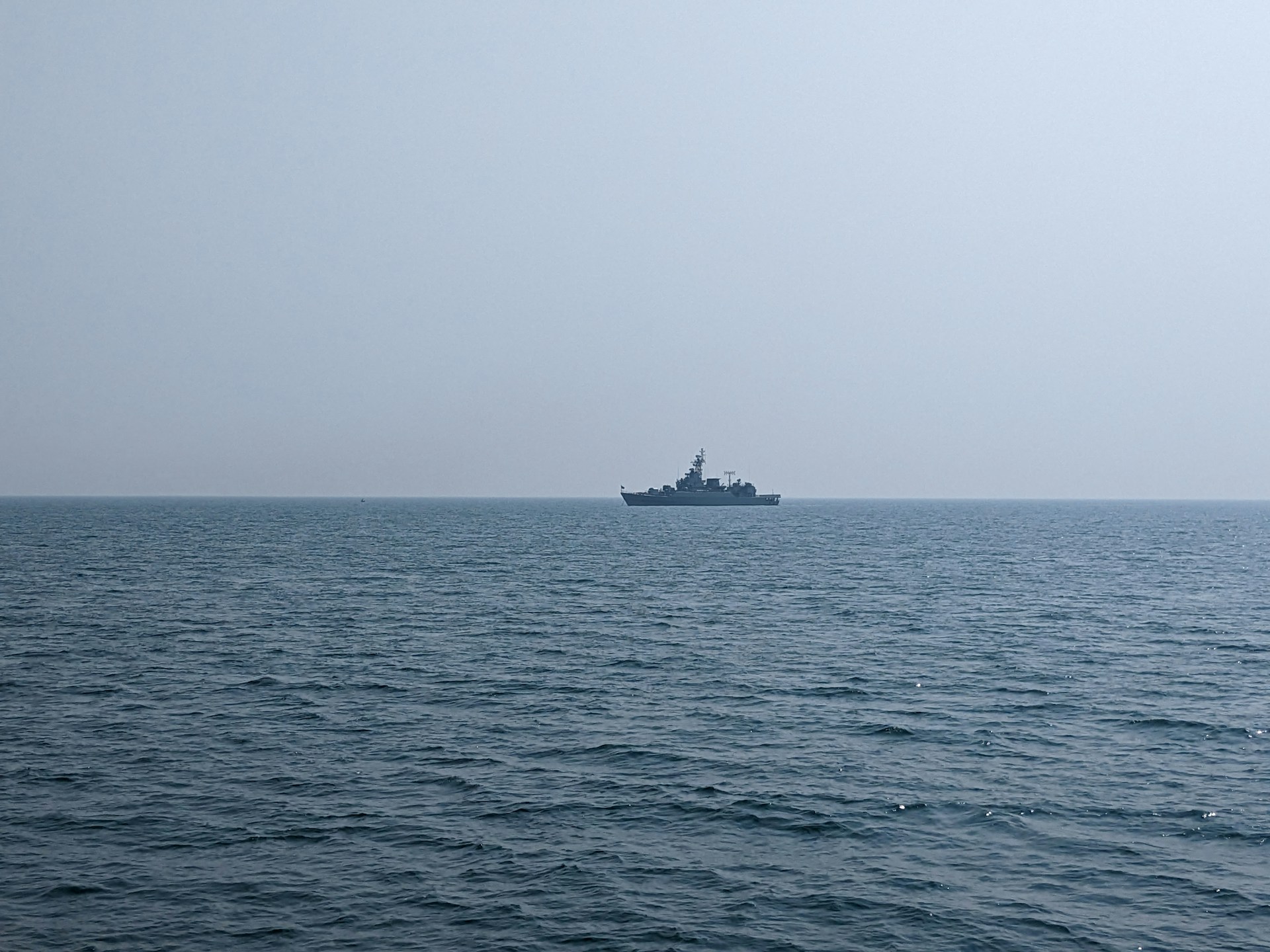 A panoramic view of a naval fleet on calm blue waters, with the brawijaya320 logo subtly overlaid.