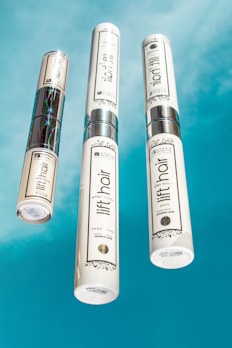 Luxurious haircare bottles with delicate floral accents on a clean white background.